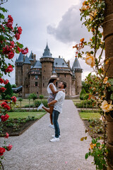 public garden of Castle de Haar in Utrecht Netherlands, people relaxing in the park near the castle...