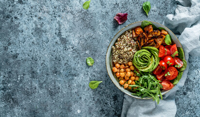 Fototapeta na wymiar Buddha bowl salad with baked sweet potatoes, chickpeas, quinoa, tomatoes, arugula, avocado, sprouts on light blue background with napkin. Healthy vegan food, clean eating, dieting, top view
