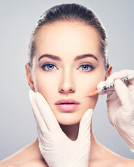 Woman getting cosmetic injection of botox near lips