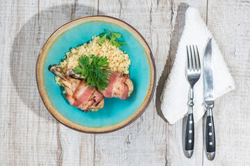 Delicious millet porridge with chicken legs and bacon