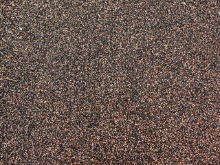 Beige-black-white stone gravel background texture. Brown small rocks abstract road pavement pattern