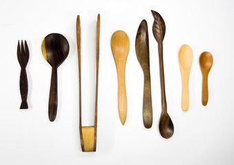 Set of cutlery and kitchen utensils made of wood. Isolated.