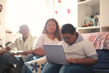 Fototapeta premium child works on the computer controlled by his parents