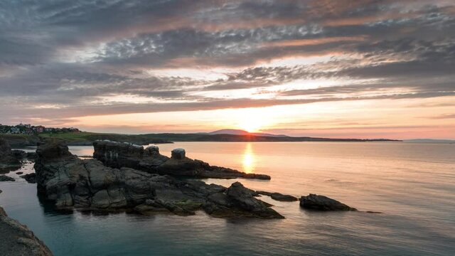Time lapse with colorful sunset sky at rocky coastline and calm summer sea, the Black Sea coast, Bulgaria