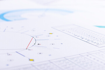 The desktop of an astrologer. The magical mysterious atmosphere of the working environment of the predictor of the future. Printouts of astrological charts and tables scattered across the table.