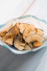 Delicious crispy coconut chips with salted caramel. Natural product made from coconut pulp. Useful snack for a snack. The concept of proper nutrition.