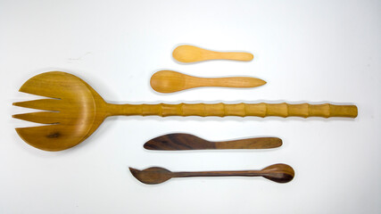 Set of cutlery and kitchen utensils made of wood. Isolated.