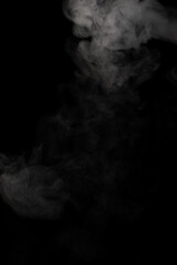 A stream of white smoke on a black background mixes randomly creating bizarre swirl patterns