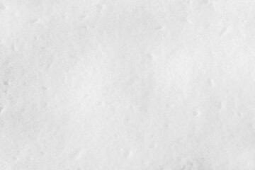 White snow on the ground on a clear sunny day. Snow texture