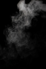 A stream of white smoke on a black background mixes randomly creating bizarre swirl patterns