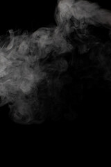 A stream of white smoke on a black background mixes randomly creating bizarre swirl patterns
