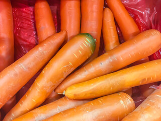 Fresh carrots for sale at the supermarket. The carrot is a root vegetable, usually orange in colour, though purple, black, red, white, and yellow cultivars exist