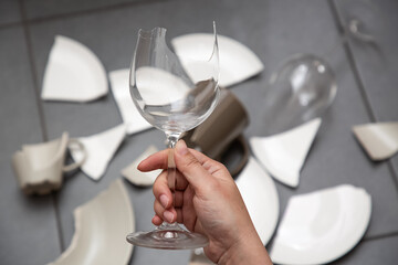 Broken Plate or broken water glass and dishes on the floor in the kitchen room The concept of accidents in the kitchen is dangerous for the body and young children inside the house.