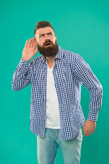 Bearded man concentrated on listening. Hearing problems. What. Eavesdrop on conversations. Deafness...