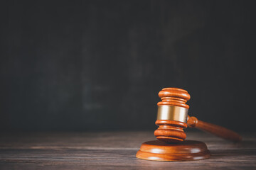 Old wood Judge hammer with law book on the table wood background, Used for adjudication and Justice.