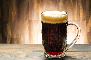 Dark beer in glass on table in pub with copy space