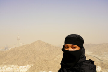 Eyes young muslim woman portrait in Ghar Thowr, Mecca, Saudi Arabia, in a sunny and clear sky day