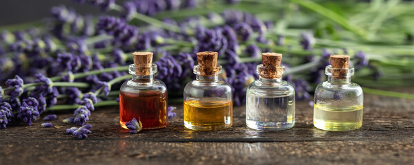 Panoramic header of essential oil bottles and lavender flowers