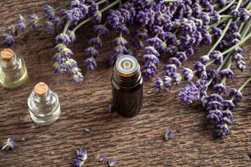 Fototapeta na wymiar A bottle of essential oil with fresh blooming lavender