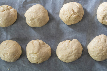 Uncooked burger bun dough in tray top view