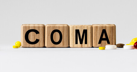 cubes with the word coma on them. Care concept.