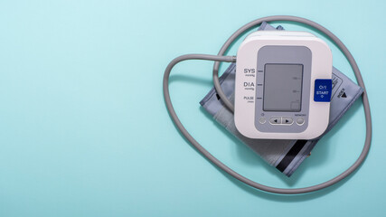 Device for measuring blood pressure on a blue medical background. Copy space.