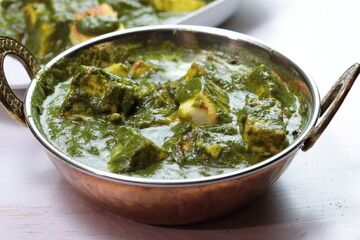 A bowl of Palak Paneer made of Paneer cheese dipped in mildly spiced Spinach gravy.