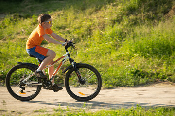 Fototapeta na wymiar Teenager riding a bicycle, closeup, selective focus