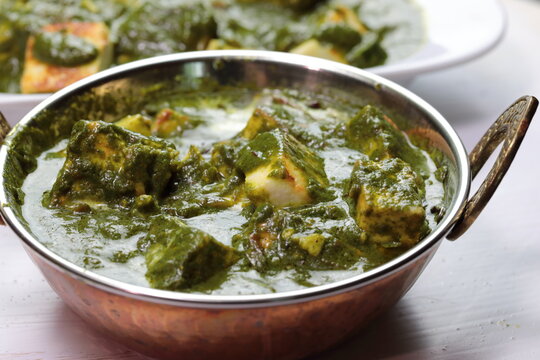 A bowl of Palak Paneer made of Paneer cheese dipped in mildly spiced Spinach gravy.