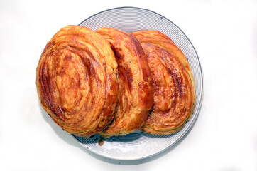 Gogal Traditional Azerbaijani Cookie on Novruz Easter . Novruz holiday with Azerbaijan national pastry Gogal and glass . Fresh pastries Gogal isolated on white background.