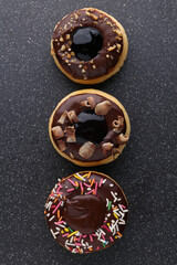  donut decorated with colorful sprinkles isolated on white background. Flat lay. Top view