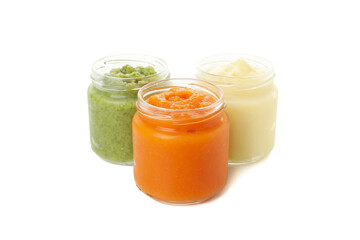 Glass jars with healthy baby food isolated on white background