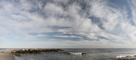 Panoramic view of Atlantic Ocean with beautiful sky. Rockaway Beach New York. USA.