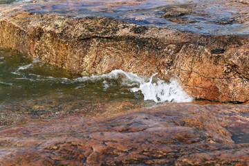 Waves hitting rocks in Helsinki, Finland. Beautiful photo representing the power and strength of...