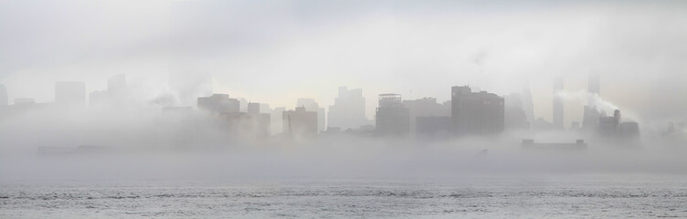 Panoramic view of midtown Manhattan skyline shrouded in mist. New York. USA.