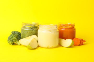 Composition with vegetable puree on yellow background. Baby food