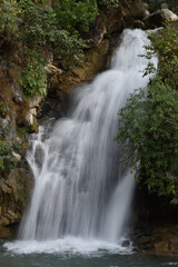 Fototapeta na wymiar long exposure of a waterfall in the mountains