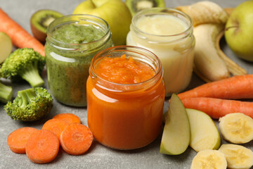 Composition with baby food on gray background, close up