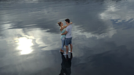 hugging couple in calm water
