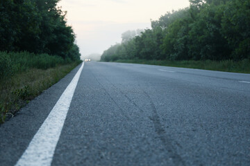 Obraz premium Foggy morning road. Beautiful summer morning. Travel