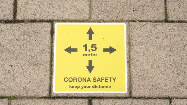 Corona virus social distancing street tile, warning to keep 1,5 meters distance .