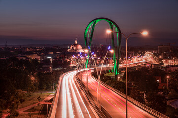 Night car traffic  on University Route in Bydgoszcz by night.  View of modern bridge over Brda...