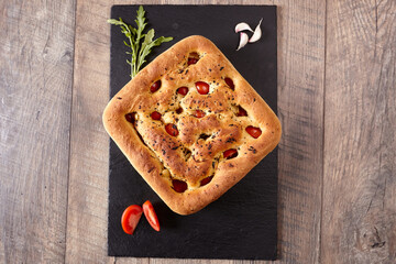 Italian focaccia with tomatoes, garlic and basil