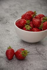 White bowl of strawberries