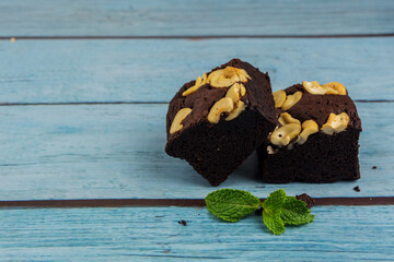 Homemade chocolate brownie on a blue wood background , bakery and dessert