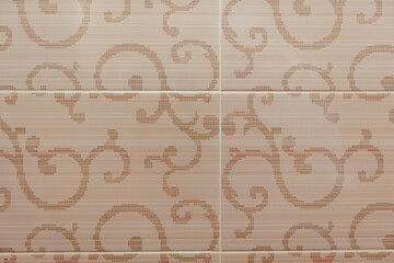 Fototapeta na wymiar Beige ceramic tile with a plant pattern