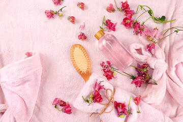Obraz na płótnie Canvas Spa ingredients with fragrant flowers of wild orchids for skin and body care, rose water and a towel on a bathrobe, aromatherapy, lifestyle concept, greeting card for invitation and advertising