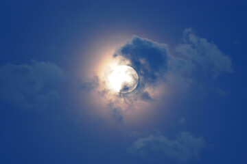 Naklejka na ściany i meble Clouds in the moonlight from full moon. Blue hour.