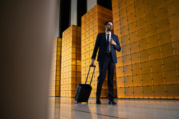 Handsome young manager trying to find a reception desk of a guest house