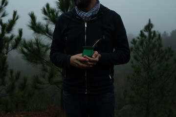 Hands holding mate to drink in the mountain